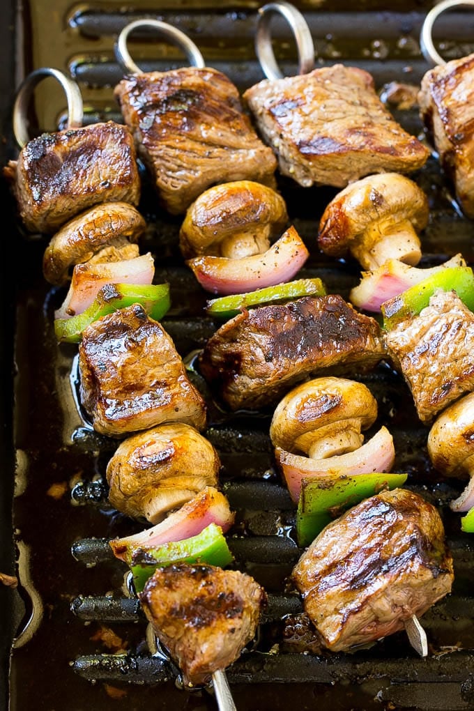 Steak kabobs on a grill pan.