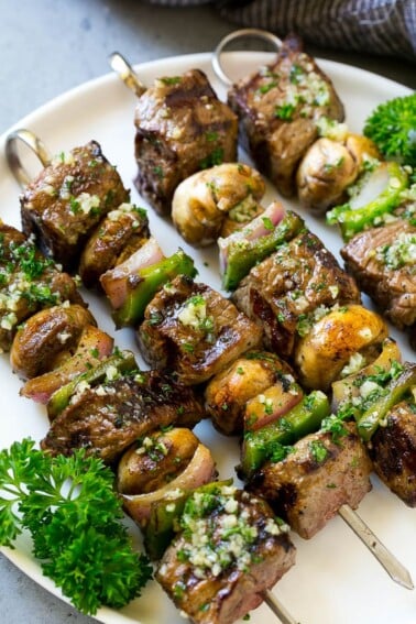 Steak kabobs with mushrooms, red onion and bell peppers, brushed with garlic butter.