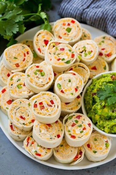 Taco pinwheels made with cream cheese, chicken, cheddar cheese and bell peppers.