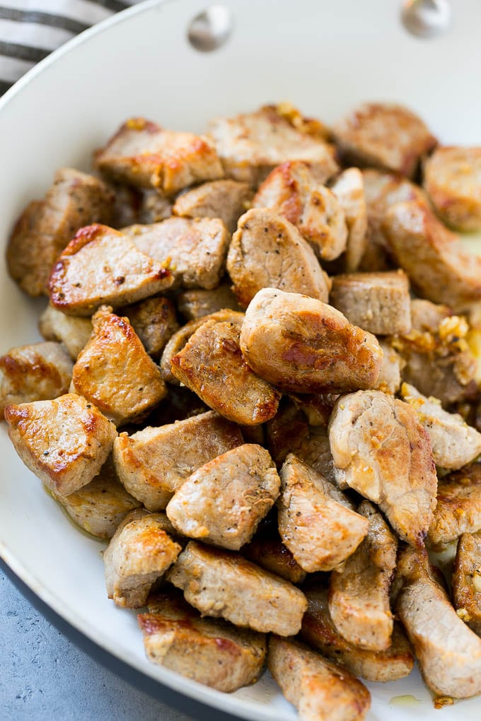 Seared pork tenderloin in a skillet.