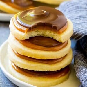 A stack of Twix cookies with a bite taken out of one.