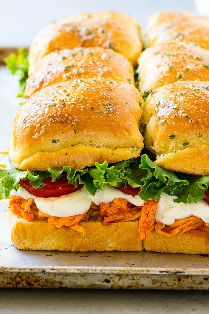 Buffalo chicken sliders with shredded buffalo chicken, lettuce, tomato and ranch sauce.