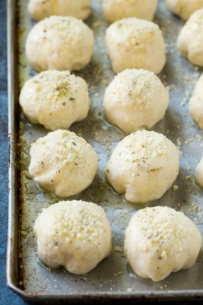 Biscuit dough wrapped around cheese cubes and topped with garlic butter and parmesan.