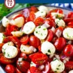 This summery cherry tomato salad is made with ripe cherry tomatoes, fresh mozzarella, herbs and red onions, all tossed in a light garlic and herb dressing.