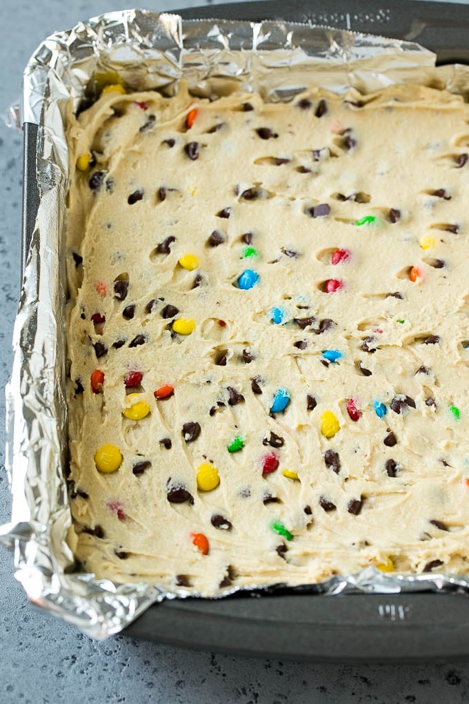 Edible cookie dough spread into a square baking pan.