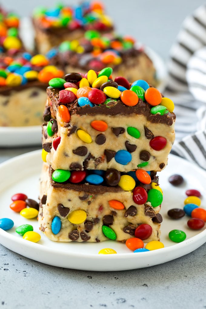 Cookie dough bars stacked on top of each other on a plate.