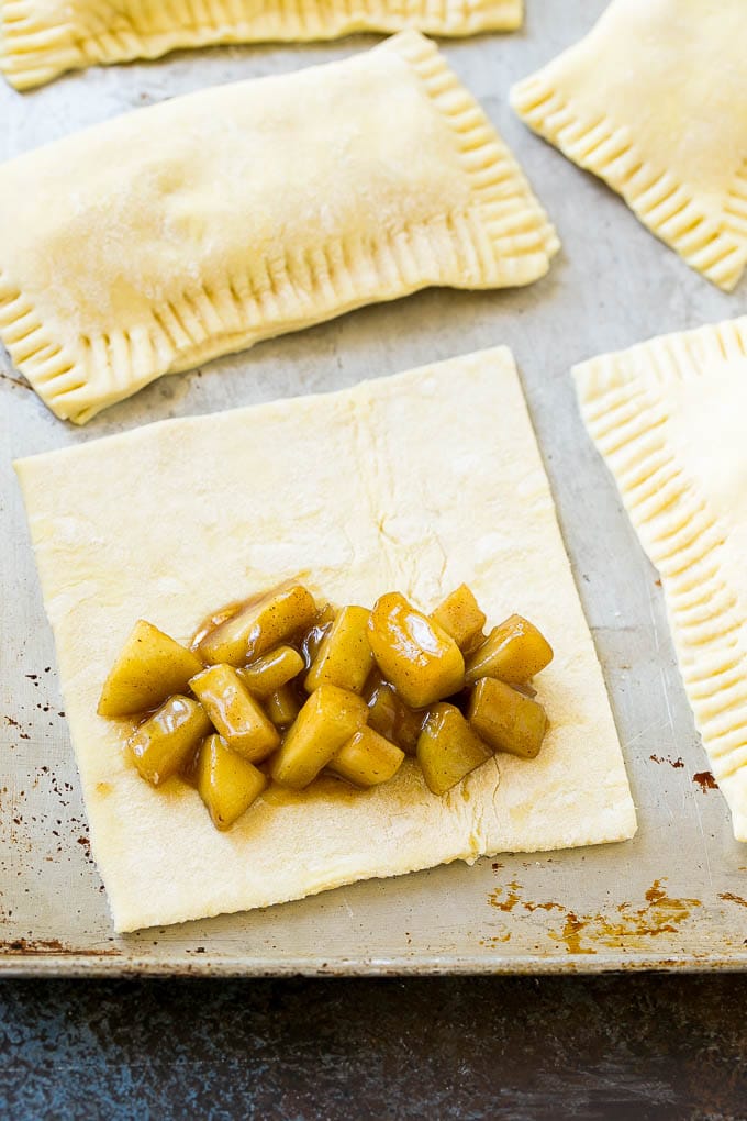 A sheet of puff pastry topped with homemade apple pie filling.
