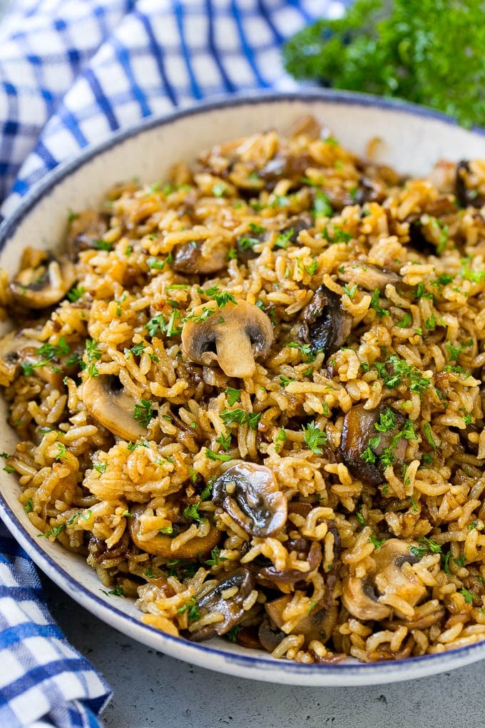 A bowl of baked mushroom rice topped with chopped parsley.