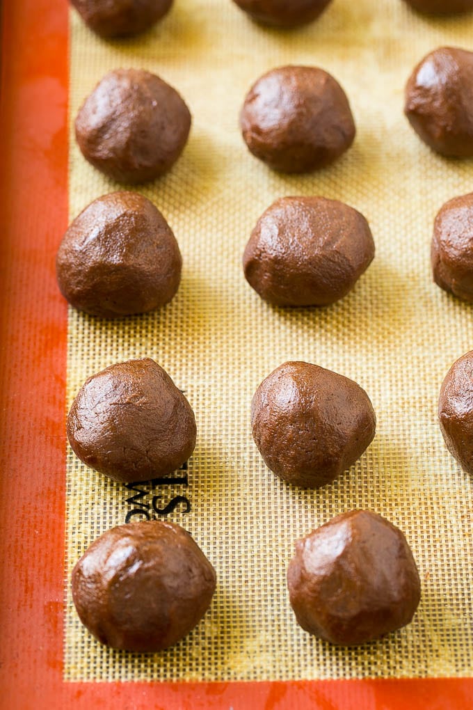 Nutella Cookies Recipe | Nutella Stuffed Cookies | Chocolate Cookies #nutella #chocolate #cookies #baking #dessert #dinneratthezoo Balls of chocolate cookie dough on a baking sheet.