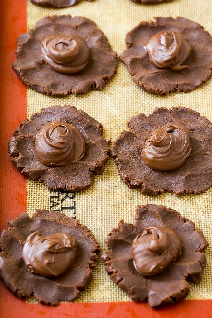 Nutella Cookies Recipe | Nutella Stuffed Cookies | Chocolate Cookies #nutella #chocolate #cookies #baking #dessert #dinneratthezoo Cookie dough with dollops of nutella in the center.