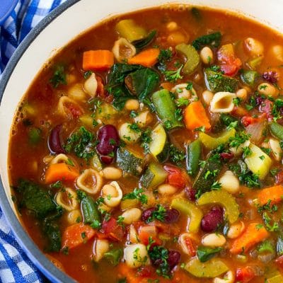 A pot of Olive Garden minestrone soup loaded with vegetables, beans and pasta.