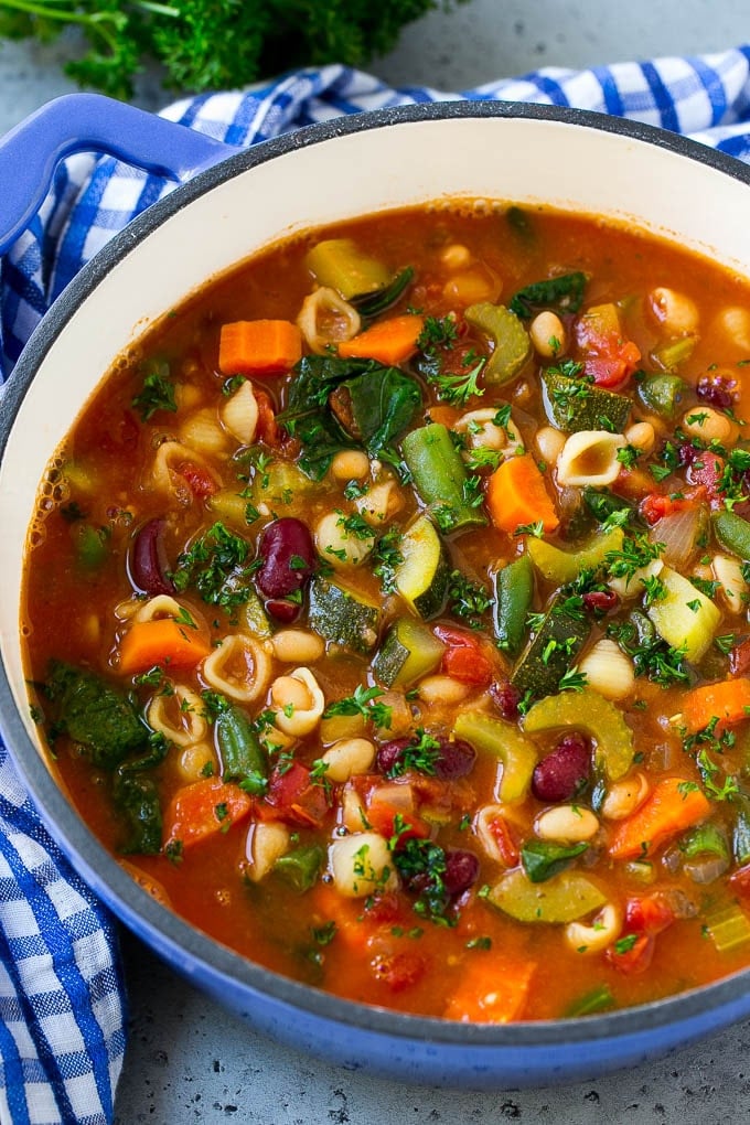 A pot of Olive Garden minestrone soup loaded with vegetables, beans and pasta.