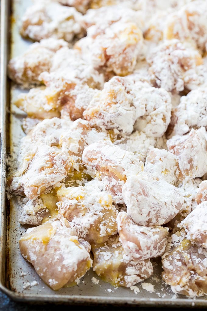 Chicken pieces coated in egg and flour.