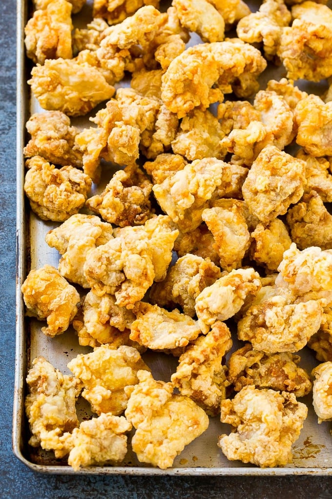 Crispy fried chicken on a sheet pan.