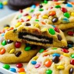 A plate of Oreo stuffed cookies topped with miniature M&M's.