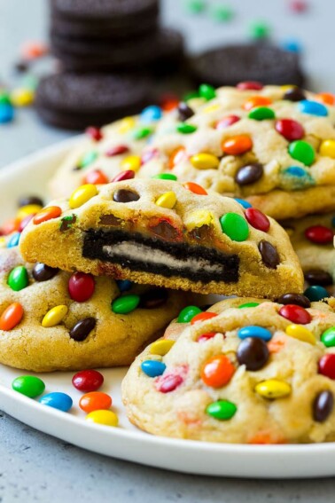 A plate of Oreo stuffed cookies topped with miniature M&M's.