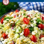 This Greek orzo salad is made with cucumbers, chickpeas, tomatoes, red onion, feta and herbs, all tossed in a herb dressing.