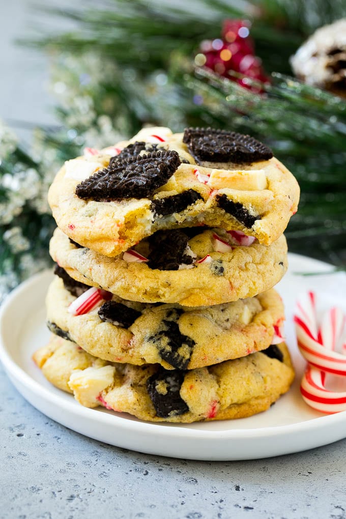 A stack of Oreo peppermint cookies on a plate, garnished with candy canes.