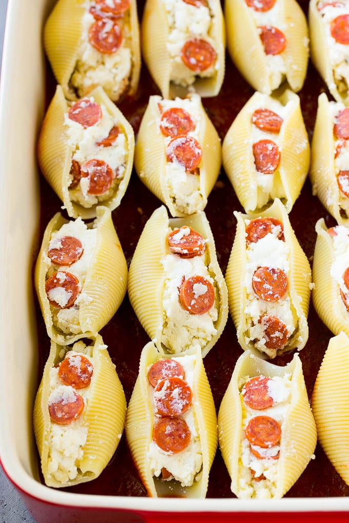Pasta shells stuffed with ricotta cheese in tomato sauce.