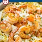 This shrimp Alfredo pasta is made with fettuccine in a creamy parmesan sauce, topped with sauteed garlic shrimp.