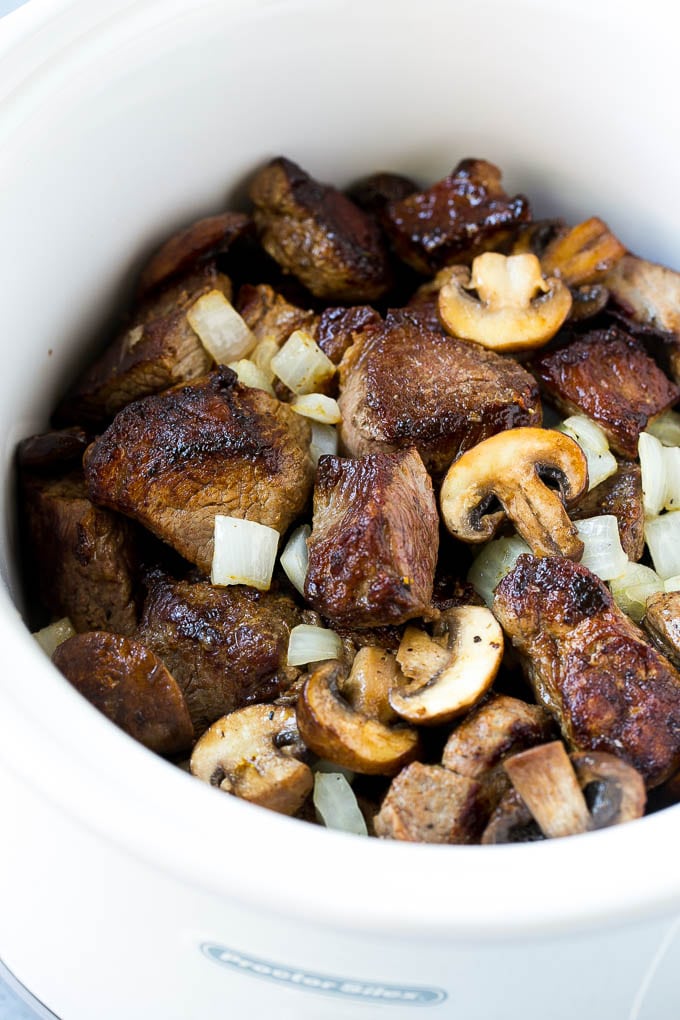 Seared beef, mushrooms and onions in a slow cooker.