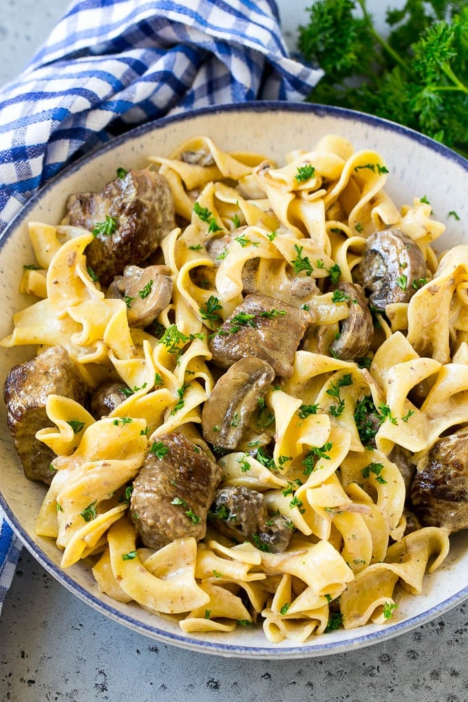 A bowl of slow cooker beef stroganoff with egg noodles.