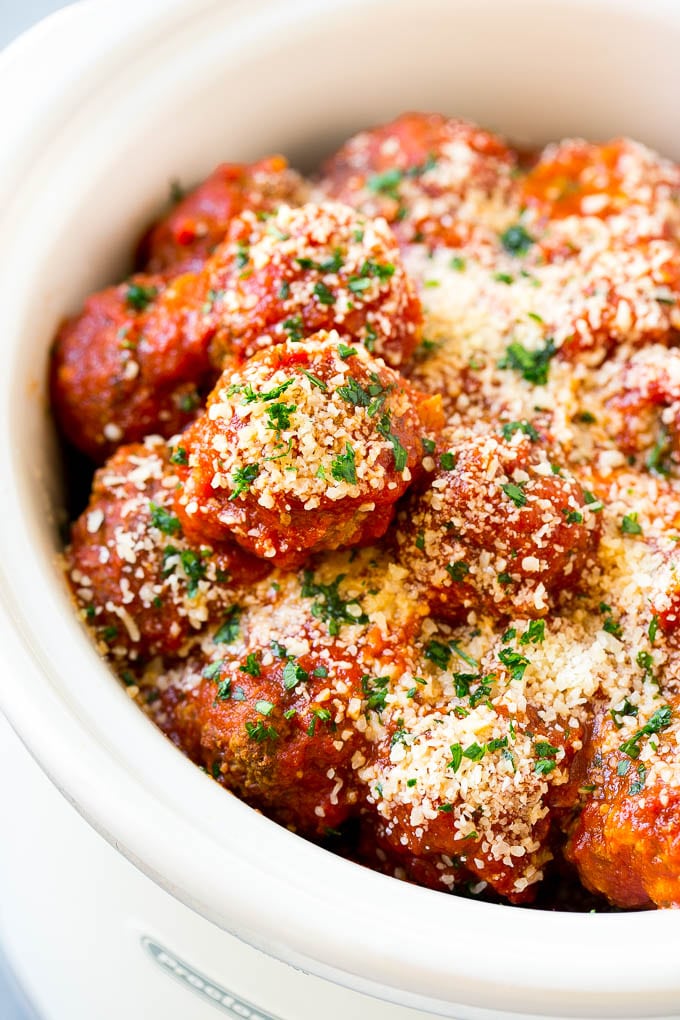Slow cooker meatballs with tomato sauce and parmesan cheese.