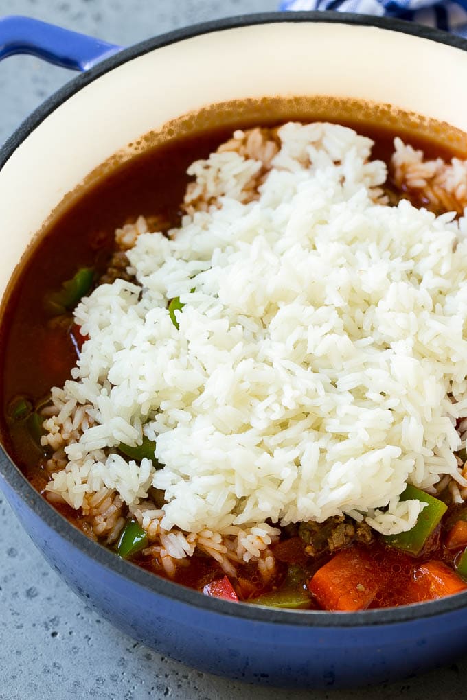 Cooked rice being on top of soup. 