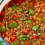 A pot of stuffed pepper soup with rice, ground beef, tomatoes, onions and bell peppers.