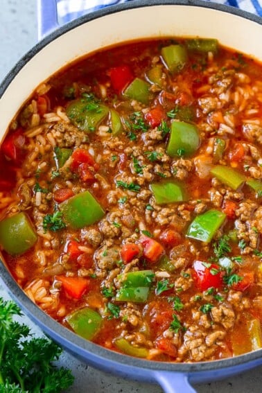 A pot of stuffed pepper soup with rice, ground beef, tomatoes, onions and bell peppers.