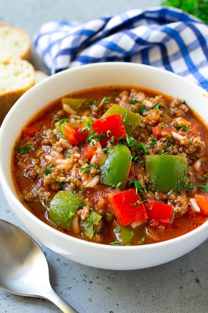 A bowl of stuffed pepper soup with ground beef, peppers and rice.