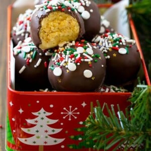 Cake truffles in a tin with a bite taken out of one.