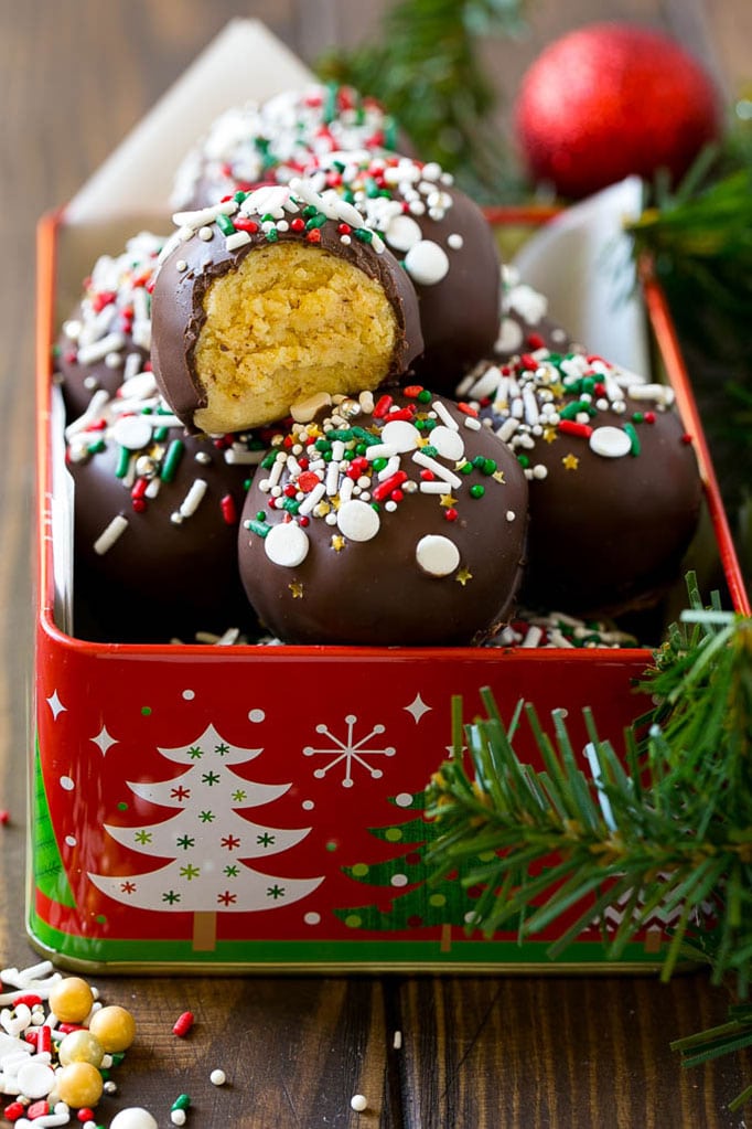 Cake truffles in a tin with a bite taken out of one.