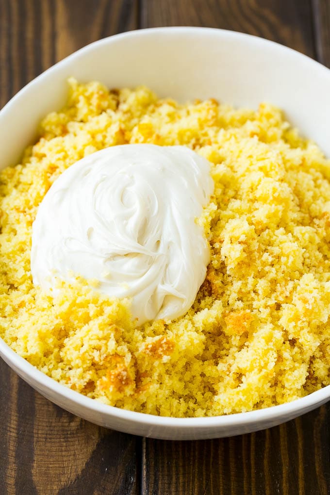 A bowl of cake crumbs and vanilla frosting.