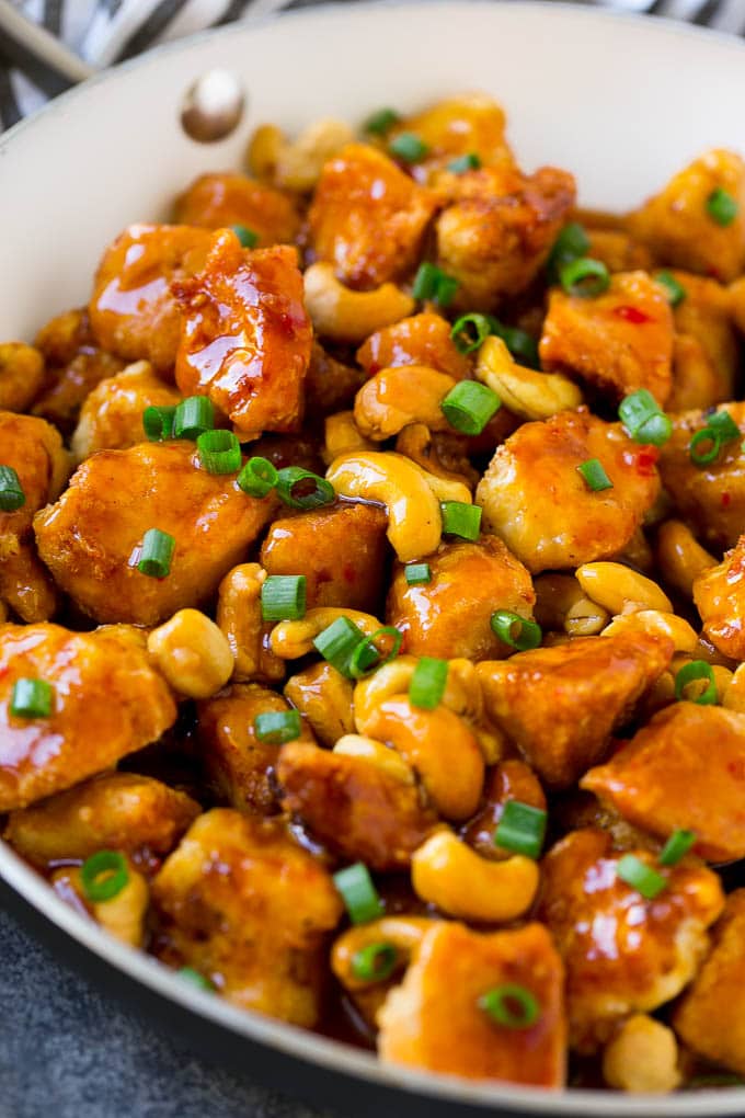 A pan of cashew chicken with crispy chicken in a sweet and savory sauce.
