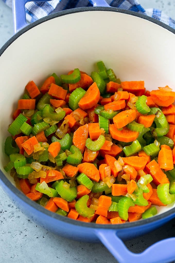 Carrots, onion and celery in a soup pot.