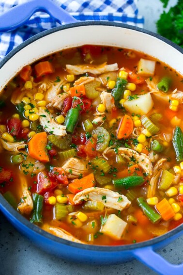 Chicken vegetable soup full of chicken, veggies and potatoes in tomato broth.