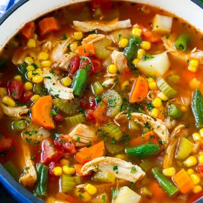 Chicken vegetable soup full of chicken, veggies and potatoes in tomato broth.