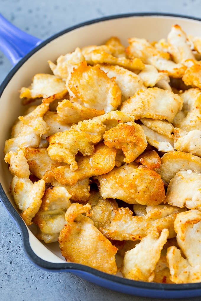 Crispy sliced chicken breast in a pan.