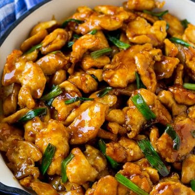 Mongolian chicken with green onions in a skillet.