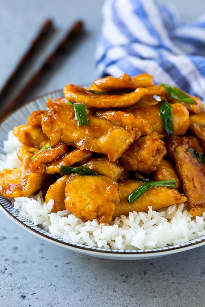 Mongolian chicken served over a bowl of rice.