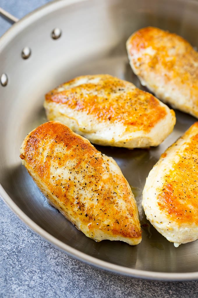 Seared chicken breasts in a skillet.