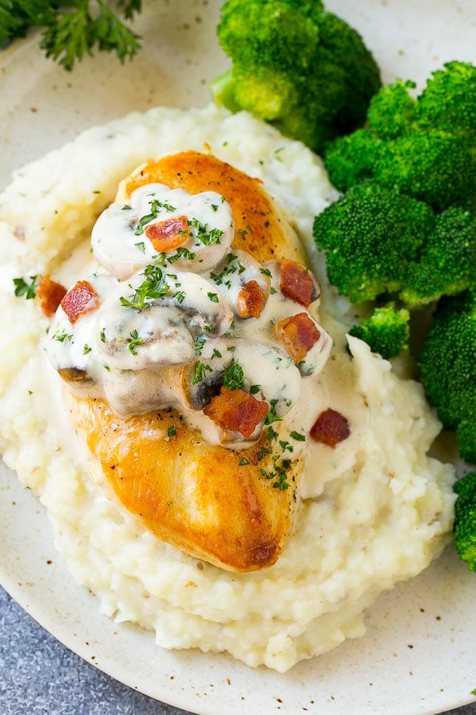 Mushroom chicken served with mashed potatoes and broccoli.