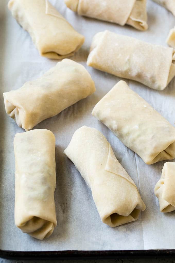 Wrapped up Philly cheesesteak egg rolls ready for the fryer.