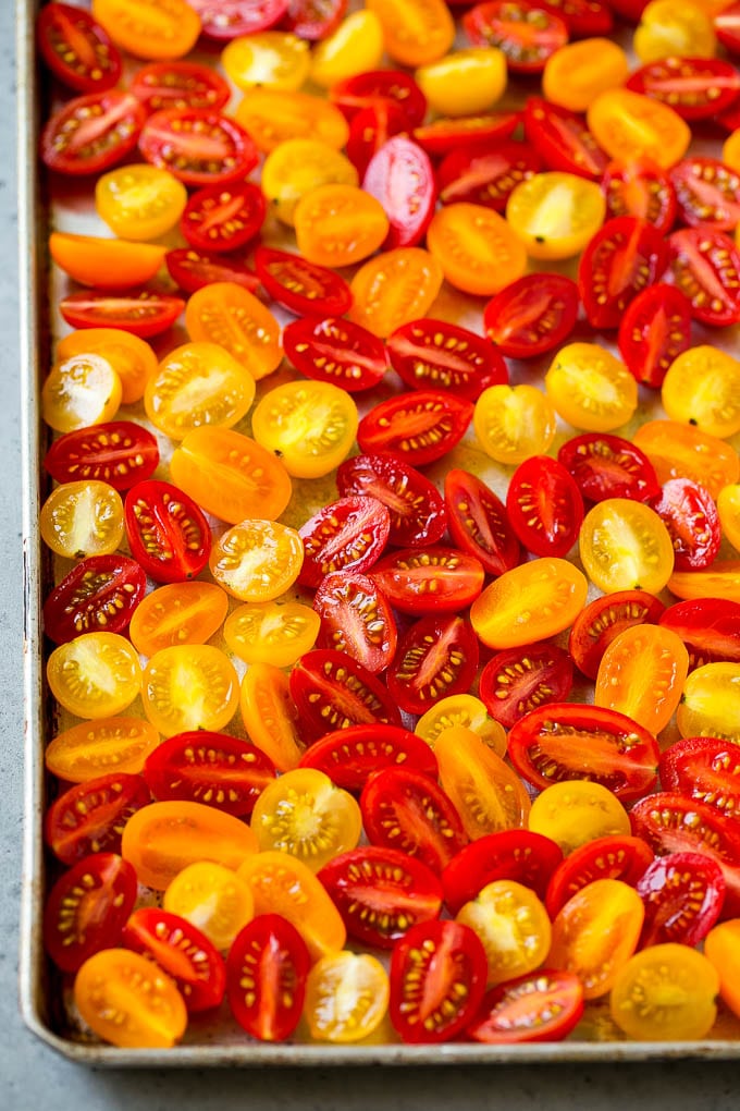 Halved red, orange and yellow cherry tomatoes.