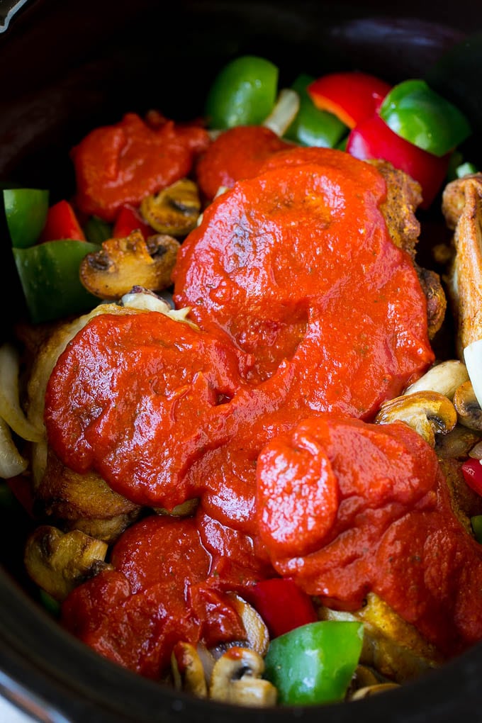 Marinara sauce poured over chicken and vegetables.