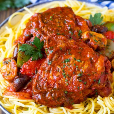 Slow cooker chicken cacciatore served over pasta.