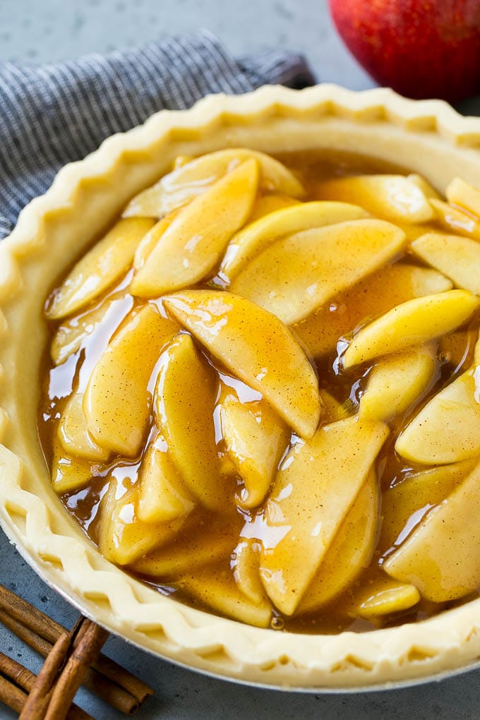 An unbaked pie crust filled with homemade apple pie filling.