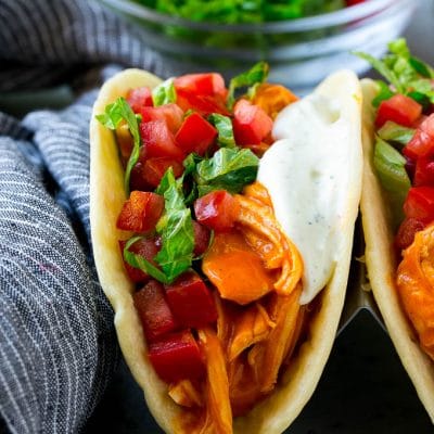 Buffalo chicken tacos with spicy chicken, diced tomato, shredded lettuce and ranch dressing.