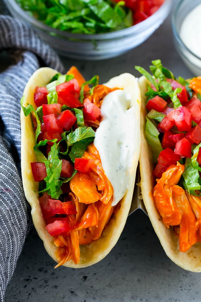 Buffalo chicken tacos filled with shredded chicken, lettuce, tomato and ranch sauce.